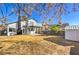 Backyard featuring a patio area, shed, wood fence, and two-story home with a second story deck at 5825 Bent Branch Ln, Las Vegas, NV 89142