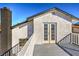 A balcony with a wooden surface, a white handrail and a view of the backyard at 5825 Bent Branch Ln, Las Vegas, NV 89142