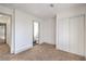 Bedroom features carpet floors, closet with sliding doors and doorway view to the bathroom at 5825 Bent Branch Ln, Las Vegas, NV 89142