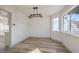 Bright dining room featuring hardwood floors, multiple windows, and modern lighting fixtures at 5825 Bent Branch Ln, Las Vegas, NV 89142