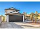 Charming two-story home featuring a spacious two-car garage and mature palm trees at 5825 Bent Branch Ln, Las Vegas, NV 89142
