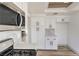 Modern kitchen with white cabinets, stainless steel appliances, and stylish backsplash at 5825 Bent Branch Ln, Las Vegas, NV 89142