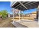 Covered patio and backyard with shed and wood fence and small tree at 5825 Bent Branch Ln, Las Vegas, NV 89142