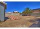 The backyard features a brick patio, xeriscaping and a mature palm tree providing shade and privacy at 6042 Thorne Bay Ct, Las Vegas, NV 89110