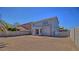 Spacious backyard ready for landscaping with a quaint brick patio and tall concrete block wall at 6042 Thorne Bay Ct, Las Vegas, NV 89110