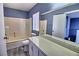 Bathroom with shower-tub combo, blue walls, white fixtures, luxury vinyl plank flooring and a single sink vanity at 6042 Thorne Bay Ct, Las Vegas, NV 89110