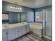 Bright bathroom featuring a double vanity, soaking tub with separate shower stall, and luxury vinyl plank flooring at 6042 Thorne Bay Ct, Las Vegas, NV 89110