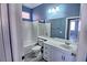 Bathroom featuring a shower-tub combo, sink with vanity, and a large mirror at 6042 Thorne Bay Ct, Las Vegas, NV 89110