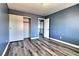 Charming bedroom featuring laminate flooring and a spacious closet with sliding doors at 6042 Thorne Bay Ct, Las Vegas, NV 89110