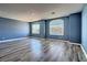 Bonus room featuring neutral walls, gray laminate floors, and two large windows at 6042 Thorne Bay Ct, Las Vegas, NV 89110