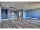 Bonus room featuring neutral walls, gray laminate floors, and a staircase at 6042 Thorne Bay Ct, Las Vegas, NV 89110