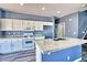 Kitchen with granite counters, kitchen island, stainless appliances, and white cabinetry at 6042 Thorne Bay Ct, Las Vegas, NV 89110