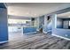Open kitchen with white appliances and cabinets, a breakfast bar and modern flooring at 6042 Thorne Bay Ct, Las Vegas, NV 89110