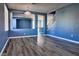 Open-concept living area featuring modern floors, blue walls and a pass through to the living room and kitchen at 6042 Thorne Bay Ct, Las Vegas, NV 89110
