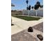 View of a backyard with desert landscaping, concrete area, artificial turf, and a block wall fence at 6241 Pinewood Ave, Las Vegas, NV 89103