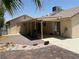 Exterior view of the home and backyard, featuring a covered patio and desert landscaping at 6241 Pinewood Ave, Las Vegas, NV 89103