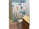 Cozy bathroom featuring a seashell themed shower curtain, toilet, and light countertop vanity at 6241 Pinewood Ave, Las Vegas, NV 89103