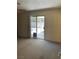 Bright bedroom features neutral paint, carpeted floors, and a sliding door to patio at 6241 Pinewood Ave, Las Vegas, NV 89103