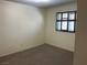 Comfortable bedroom features neutral paint, carpeted floors, and a window at 6241 Pinewood Ave, Las Vegas, NV 89103