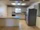 Bright kitchen featuring white cabinets, stainless steel appliances, and a tiled floor at 6241 Pinewood Ave, Las Vegas, NV 89103