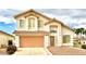Beautiful two-story home featuring a well-manicured lawn, tile roof, and a two-car garage in a desirable neighborhood at 66 John Stuart Mill St, Henderson, NV 89002