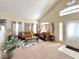 Bright living room featuring plush carpeting, comfortable seating, and large windows, providing ample natural light at 66 John Stuart Mill St, Henderson, NV 89002