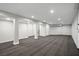Finished basement featuring neutral carpet, support columns, and access to stairs at 7060 W Rome Blvd, Las Vegas, NV 89131