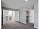 Bedroom with doors leading to balcony and closet at 7060 W Rome Blvd, Las Vegas, NV 89131