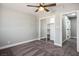 This bedroom features carpet floors, a ceiling fan, and a sliding door closet at 7060 W Rome Blvd, Las Vegas, NV 89131