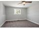 Bedroom featuring neutral carpet, a window, and a ceiling fan with a light at 7060 W Rome Blvd, Las Vegas, NV 89131
