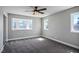 Spacious bedroom with a ceiling fan, natural light, and plush carpeting at 7060 W Rome Blvd, Las Vegas, NV 89131