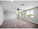 Spacious bedroom with windows, plush carpet, and neutral walls at 7060 W Rome Blvd, Las Vegas, NV 89131