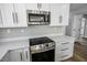 This kitchen features stainless steel appliances, white cabinets, and stone countertops at 7060 W Rome Blvd, Las Vegas, NV 89131