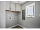 This laundry room features white cabinets, hard floors, and a window at 7060 W Rome Blvd, Las Vegas, NV 89131
