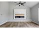 This living room includes a fireplace, hard floors, and a ceiling fan at 7060 W Rome Blvd, Las Vegas, NV 89131