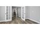 The living room is complete with hard floors, white trim, and a staircase at 7060 W Rome Blvd, Las Vegas, NV 89131