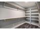 Walk-in closet with shelving and wood rails at 7060 W Rome Blvd, Las Vegas, NV 89131