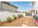 Backyard featuring desert landscaping, a stone walkway, and a white brick fence at 7384 Valhalla Ln, Las Vegas, NV 89123