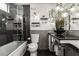 Modern bathroom featuring a glass shower, decorative shelving and lighting, and grey brick tiling at 7384 Valhalla Ln, Las Vegas, NV 89123