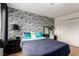 Bedroom with brick accent wall, and natural light from the window at 7384 Valhalla Ln, Las Vegas, NV 89123