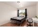 Bright bedroom with a large window, hardwood floors, and a chandelier at 7384 Valhalla Ln, Las Vegas, NV 89123