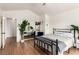 Stylish bedroom featuring hardwood floors, a large plant and wall decor at 7384 Valhalla Ln, Las Vegas, NV 89123