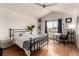 Light filled bedroom features hardwood floors and a desk by the window at 7384 Valhalla Ln, Las Vegas, NV 89123