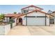 Charming two-story home featuring a well-maintained lawn, driveway, and Spanish style roof at 7384 Valhalla Ln, Las Vegas, NV 89123