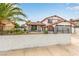 Charming two-story home featuring a well-maintained lawn and Spanish style roof at 7384 Valhalla Ln, Las Vegas, NV 89123