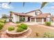Landscaped front yard with mature trees, shrubbery, and gravel in a well-maintained design at 7384 Valhalla Ln, Las Vegas, NV 89123