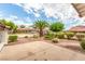 Landscaped front yard with mature trees, shrubbery, and gravel in a well-maintained design at 7384 Valhalla Ln, Las Vegas, NV 89123