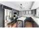 Modern kitchen with stainless steel appliances, gray cabinetry, and center island at 7384 Valhalla Ln, Las Vegas, NV 89123