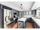 Updated kitchen with stainless steel appliances, grey cabinetry, hardwood floors and plenty of counter space at 7384 Valhalla Ln, Las Vegas, NV 89123