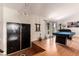 Bright living room boasts a stylish chandelier, a billiard table, and hardwood floors at 7384 Valhalla Ln, Las Vegas, NV 89123